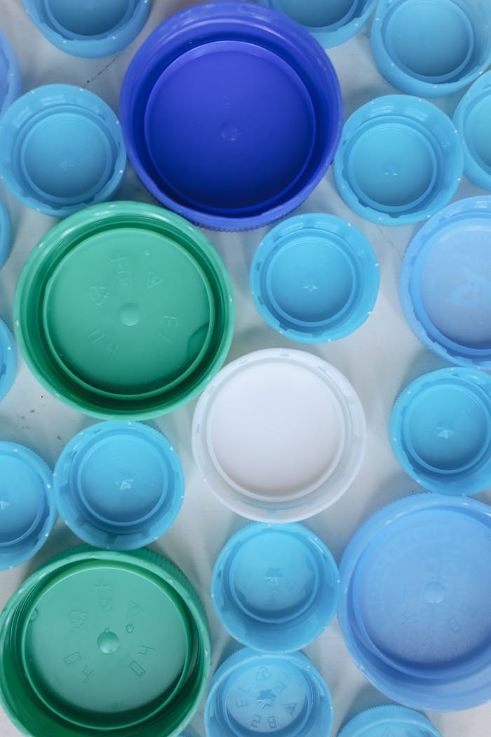 Aerial view of assorted colorful plastic bottle caps highlighting recycling and sustainability.